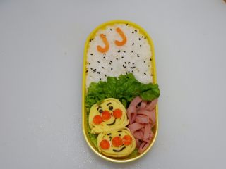 34、卡通面包超人便当「10」,最后撒少许黑芝麻装饰即可。