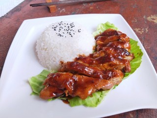 15、照烧鸡腿饭,然后把剩余的汤汁浇在鸡肉表面，再撒一些黑胡椒碎。香喷喷的照烧鸡腿饭就做好了。