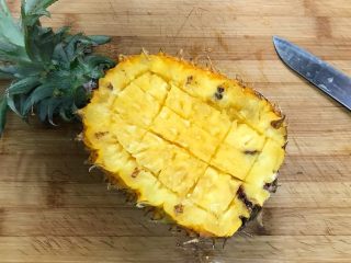 5、香甜菠萝糯米饭,用水果刀按着菠萝的轮廓划一圈,边缘留1~1.5厘米左右,中间划成小方块状。