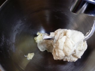 4、原味贝果（超详细版）,面团放入厨师机或面包机，先低挡打，让面团能挂上钩。打至能拉出稍薄一点的膜。如果手揉的话，用使劲搓、蹭面团的方法，因为不需要揉到完全阶段，即使手揉也不会用太久的时间。