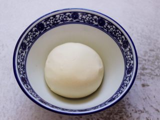 9、小苔菜虾皮花样包子,和好的面团用手揉圆,盖上保鲜膜进行醒发。