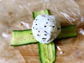 22、日式手鞠壽司飯團,接下來包黃瓜的，飯團可以適當大一點，這個黃瓜片可以完整的鋪在飯團上。