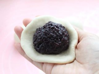 10、紫米面包,取面团按扁擀成饼皮，在中间放紫米馅。