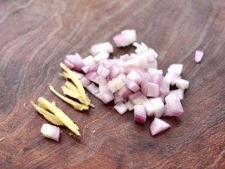 3、香辣孜然烤鱼,把洋葱用刀切碎,一片姜切成丝。
