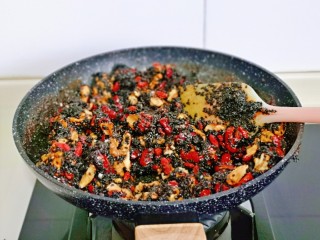 10、芝麻核桃糖,快速翻炒使糖浆后均匀裹在果仁上，这是可以关火，如果觉得糖浆多可以多翻炒一会。