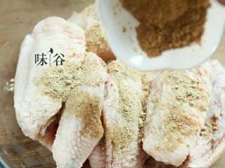 3、烤鸡翅,倒入孜然粉。