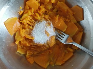 4、南瓜汤圆,把南瓜中蒸出来的水分控掉，加入白砂糖，用叉子压成南瓜泥