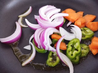 6、韩式炒年糕,把切好的蔬菜倒入锅里