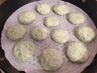 7、清明粿,蒸锅里放入适量水烧开，放上蒸笼，把揉好的面团搓成饼状，放上蒸笼，大火蒸20分钟。