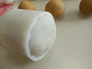 9、五彩冰皮月饼,把粘有彩色冰皮的花片，放在模具中，在把包好的冰皮月饼放入模具中，倒过来放在烤盘上。