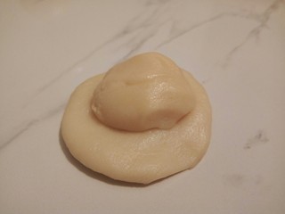 5、#甜味#凤梨蛋黄酥, 取一个油皮按扁， 放上一个油酥