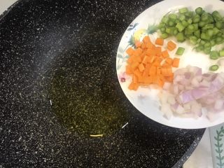 4、东南亚风味-咖喱肥牛凤梨饭团,锅中倒入少许橄榄油，放入胡萝卜丁，洋葱丁和芦笋丁翻炒出香味