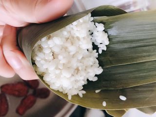 7、粽子,用手握好，加入糯米。