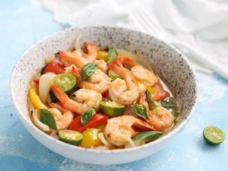 16、泰式罗勒烹虾,装盘后撒上罗勒叶，放几个切开的小青柠装点。美味的泰式罗勒烹虾就完成了。