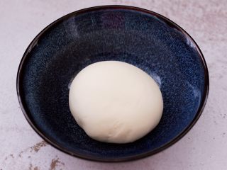7、卤肉夹馍,和好的面团,用手揉圆后,放入碗里盖上保鲜膜进行醒发。
