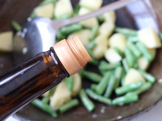 7、土豆豆角焖饭,放入生抽。