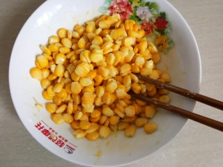 8、椒盐玉米粒,用筷子搅拌均匀。（让玉米粒均匀的裹上蛋液）