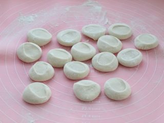 4、脆底猪肉洋葱锅贴,案板撒面粉防粘，取出饧好的面团揉匀后切割成面剂子，要比饺子的稍微大一点，用手掌按扁