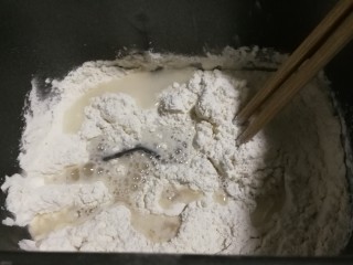 6、无泡打粉的油条,放入清水,启动面包机搅拌8分钟成湿润面团