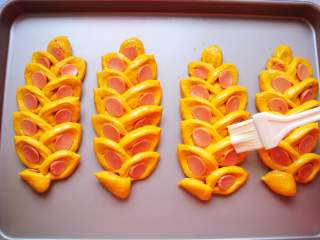 16、南瓜香肠麦穗面包,鸡蛋一个打散（分量外）在表面刷上一层全蛋液。