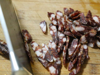 3、农家腊肠炝蒜,将腊肠切成薄片。