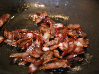 10、农家腊肠炝蒜,翻炒至腊肠变色。