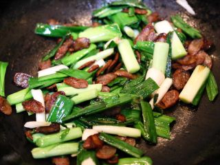 14、农家腊肠炝蒜,继续翻炒一会，至大蒜绵软即可。