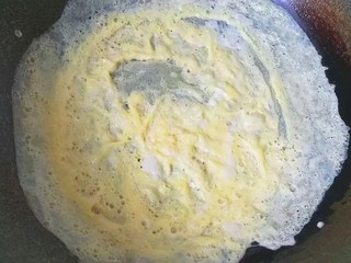 4、火腿鸡蛋炒面,鸡蛋一个打散,倒入锅中煎成鸡蛋薄饼;