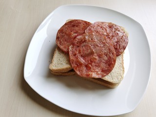 9、芝士火腿三明治,将火腿放到面包片上。