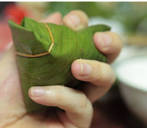 11、瑶柱酱肉粽,再反折成三角形状，尽量用自己的手指捏稳定型