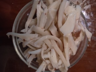 2、自制年夜饭饮料-------椰肉牛奶热饮,蒸好椰子壳用菜刀削掉表面的叶子皮，然后用锤子慢慢的起开椰子壳，用勺子挖出椰肉，用刀切成细丝备用。