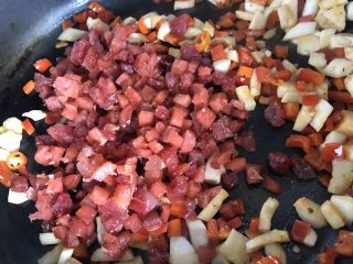 15、菠萝炒饭,接着倒入翻炒好的香肠和腊肠，一起继续翻炒均匀