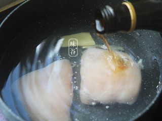 2、清爽开胃的凉拌鸡丝,鸡胸肉冷水下锅,放入姜片,倒入料酒,把鸡胸肉煮熟;