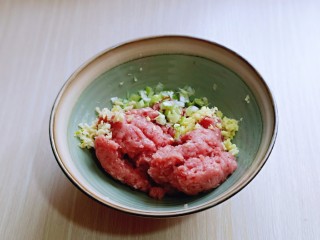 1、葱香鲜肉蒸饺,肉糜放入器具中，加入切好的葱姜。
