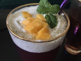 8、多肉葡萄汁儿,筛入抹茶粉，加芒果粒和薄荷叶装饰。