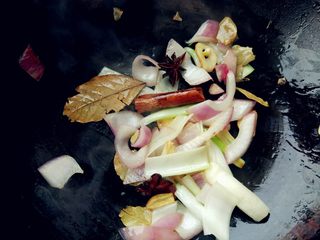 5、红烧羊蝎子,热锅热油,爆香葱、蒜、洋葱和八角、桂皮、香叶。如果用的是郫县豆瓣辣酱,也可以放入一起翻炒出香味。鲜椒酱是即食酱料,我就省略了翻炒提香的步骤