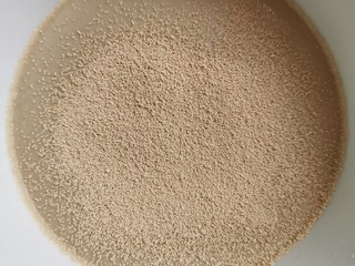 2、花样馒头之腊肠卷、小刺猬,酵母放在温水里搅拌均匀，放进泡打粉再次搅拌。