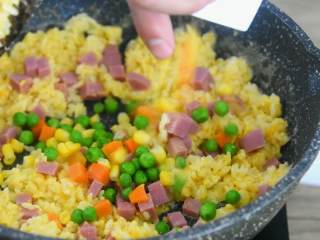 8、吃货们的福音—黄金什锦蛋炒饭，原来好吃的炒饭是这么做出来的,倒入火腿丁、杂菜继续翻炒。