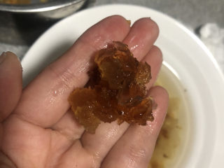 4、牛奶炖桃胶,去除桃胶里的杂质，冲洗干净。