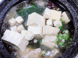11、海带骨头汤,再放入豆腐块儿,轻轻搅拌均匀。盖盖儿,小火儿慢炖20分钟。