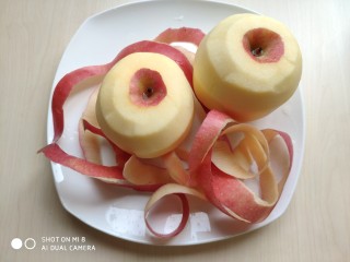 2、蜂蜜苹果糯米圆,用削皮器削去苹果皮。为了防止氧化，不要像我这样都削了皮。建议先削一个，另一个等做好圆子后再削皮。