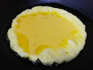 9、老黄瓜炒鸡蛋,油热倒入打散的蛋液。
