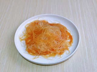 12、蒜蓉蒸大虾,泡软的粉丝放入盘中，加入1小勺生抽拌均匀。