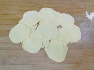 11、月牙蒸饺,将小剂子压扁，擀成中间稍厚边缘薄的蒸饺皮。