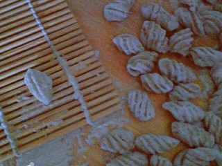 9、荞麦时鲜海螺面,取一面丁，用拇指在寿司帘上稍做推压，就是一枚可爱的海螺面啦。为防黏连，要稍微多撒一些面粉。