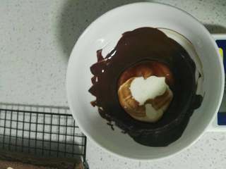 12、波点巧克力蛋糕卷,巧克力隔水融化，加入奶油A，搅拌均匀，放一边晾凉。