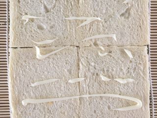 5、懒人寿司面包卷,在面包片上挤上沙拉酱