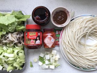 1、新疆炒米粉(家庭版),准备食材,米粉要粗的糯米米粉,前一晚就浸泡,第二天备用,西芹切小段,大葱切段,平菇撕条,把各种酱料备齐;