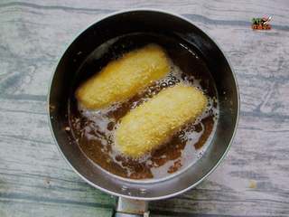 10、芝士拉丝热狗棒,热锅热油，开始油炸，金黄即可。