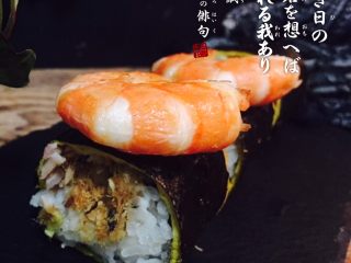 12、大虾寿司,随后用刀切，切一下，刀用冷开水冲一下，防粘。放上一个水里煮过的大虾。欧拉。